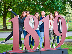 Student standing behind a 1819 sign. Links to Gifts by Will