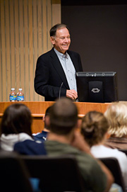 Photo of Robert A. Fox ’59 talking to a group of people